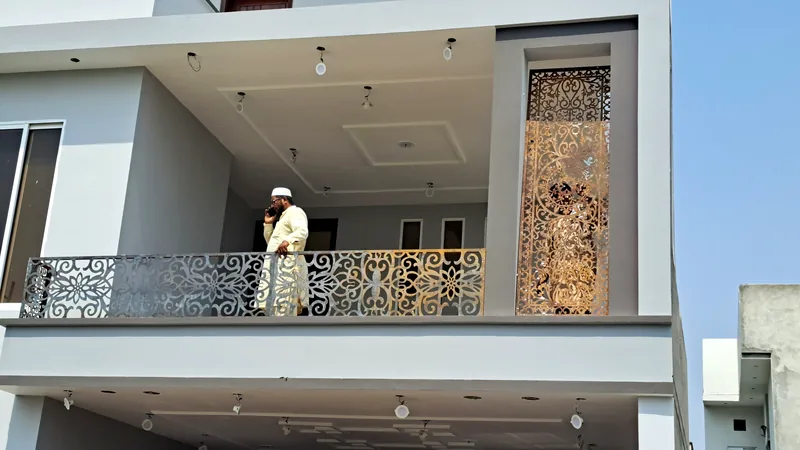 House 113 Dream Garden Multan upper balcony with decorative CNC metal railing and golden jali panel by The Niaz Builders